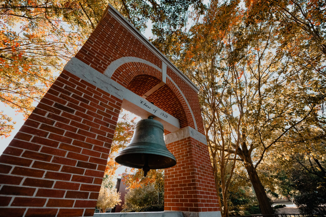 Left, bottom angle shot of the Class of 1939 Bell Tower at the Carillon Garden with fall foliage.