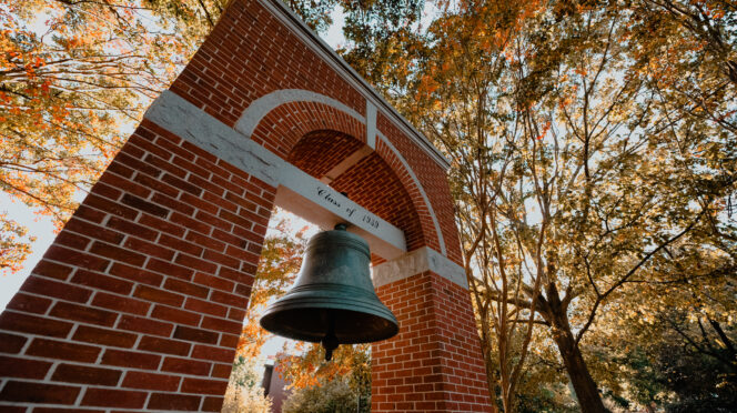 Left, bottom angle shot of the Class of 1939 Bell Tower at the Carillon Garden with fall foliage.