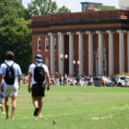 Students walk across Bowman Field toward Sikes Hall on Clemson University's campus.