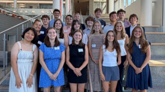 The Lyceum Scholars standing on the stairs of the Powers building.