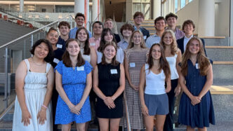 The Lyceum Scholars standing on the stairs of the Powers building.