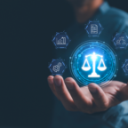 A hand holds a computerized image of the scales of justice