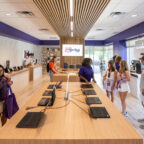 Customers browse laptops and chat with store employees inside the Tiger Tech Shop.