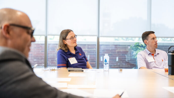 New Chair Orientation attendees listen at a table.