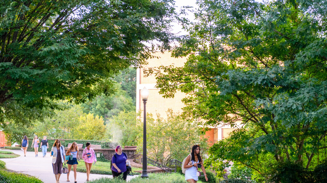 Students and staff walking across campus.
