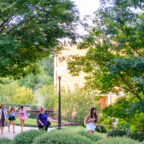 Students and staff walking across campus.
