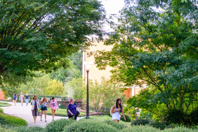 Students and staff walking across campus.