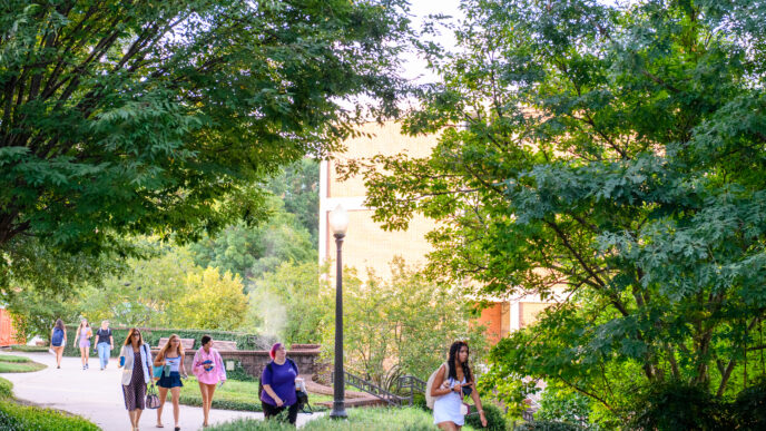 Students and staff walking across campus.
