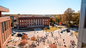 Aerial view of the campus with students walking on the streets and sidewalks