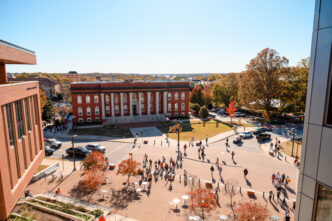 Aerial view of the campus with students walking on the streets and sidewalks
