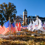 American flags and service flags displayed on Bowman Field.