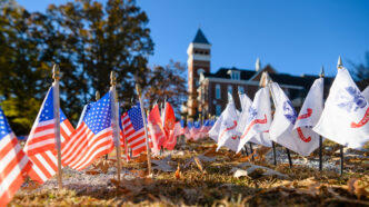 American flags and service flags displayed on Bowman Field.