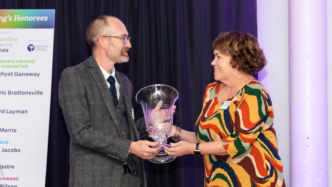 Brent Morris accepts a a glass award from SC Humanities